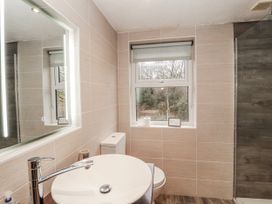 A bathroom with a sink, toilet, and shower at Greenbank Cottage Winster near Bowness-On-Windermere