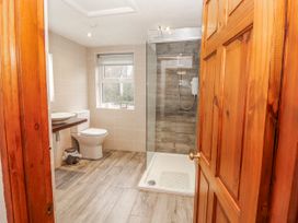 A bathroom with a shower and sink at Greenbank Cottage in Winster near Bowness-On-Windermere