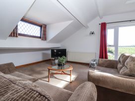 A sitting room with a television and sofa at East Cottage near Rillington