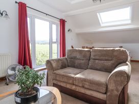 A living room with a sofa and plant at East Cottage near Rillington