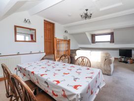 A dining room with a table and chairs at East Cottage in East Knapton near Rillington