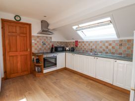 A kitchen with cabinets, stove, oven, and sink at East Cottage in East Knapton near Rillington