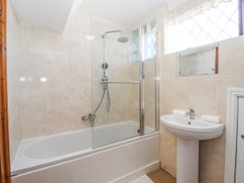A bathroom with a bathtub and shower at East Cottage in East Knapton near Rillington
