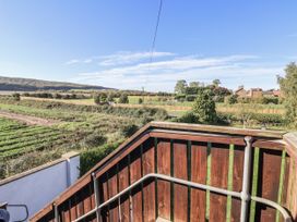 A view from a balcony overlooking a field and houses at West Cottage East Knapton near Rillington