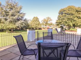 A patio with a table and chairs at West Cottage in East Knapton near Rillington