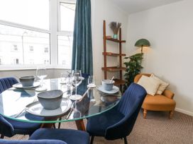 A dining room with a table set for meals at Beachcomb in Weymouth