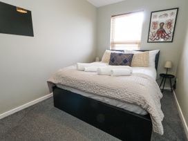 A bedroom with a bed and artwork at Beachcomb in Weymouth