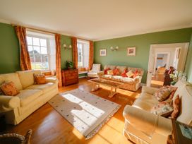 A living room with sofas and a coffee table at Porthcothan House St Merryn