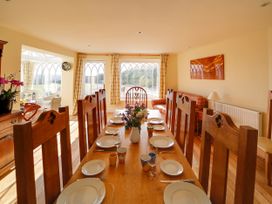 A dining room with a table set for dinner at Porthcothan House in St Merryn