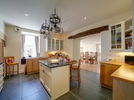 A kitchen with cabinets and an island at Porthcothan House in St Merryn