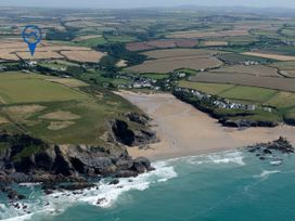 An aerial view of a beach and surrounding farmland at Porthcothan House in St Merryn