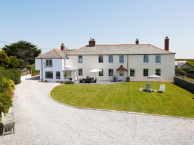 A house with a garden and outdoor seating at Porthcothan House in Porthcothan