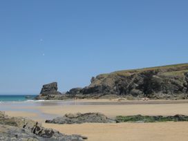 A beach with rock formations at Porthcothan House in Porthcothan