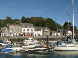 A marina with boats and buildings at Porthcothan House in Porthcothan