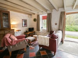 A living room with a sofa and television at Sycamore Vestry in Pontfaen near Fishguard