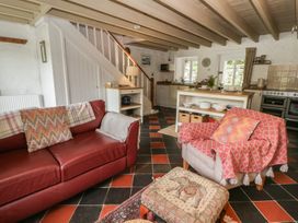 A living room with a sofa and armchair at Sycamore Vestry Pontfaen near Fishguard