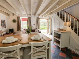 A living room with a dining table and chairs at Sycamore Vestry Pontfaen near Fishguard
