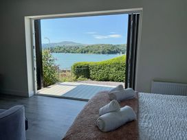 A bedroom with a view of the lake at The Old Tywyn Post Office in Deganwy