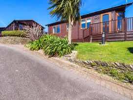 A view of cabins surrounded by plants at Chi Prenn Byhan in Tintagel