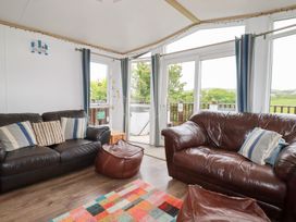 A living room with sofas and a bean bag at Orchard View in Bossiney near Tintagel