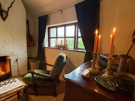 A snug with a fireplace and candles at The Captain's Nest in Bunbeg, County Donegal