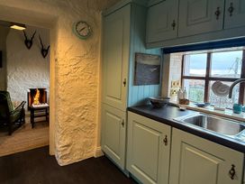 A kitchen with cabinets and a sink at The Captain's Nest in Bunbeg, County Donegal