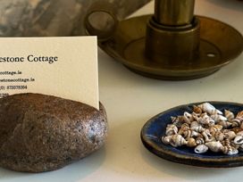 A business card holder with a card and shells at The Captain's Nest in Bunbeg, County Donegal