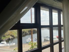 A window with a view of boats on water at The Captain's Nest Bunbeg, County Donegal