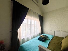 A bedroom with a bed and window at The Captain's Nest in Bunbeg, County Donegal