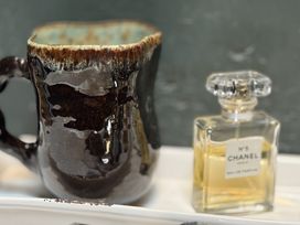 A mug and a Chanel perfume bottle at The Captain's Nest in Bunbeg, County Donegal