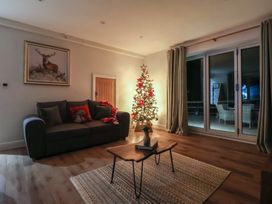 A living room with a Christmas tree and sofa at Stag Cottage in Lytchett Matravers