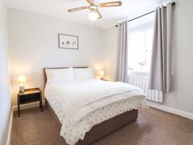 A bedroom with a bed and nightstand at Burgedin Locks Cottage Arddleen near Llandrinio