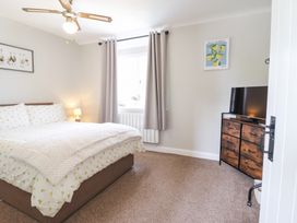 A bedroom with a bed and television at Burgedin Locks Cottage Arddleen near Llandrinio