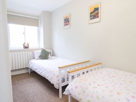 A bedroom with two beds and a window at Burgedin Locks Cottage Arddleen near Llandrinio