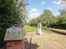 An information sign and sculpture near a path at Burgedin Locks Cottage Arddleen near Llandrinio