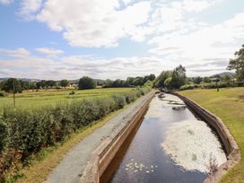 A canal with water and a path alongside at Burgedin Locks Cottage Arddleen near Llandrinio