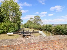 A view of a lock gate and pathway with trees at Burgedin Locks Cottage Arddleen near Llandrinio