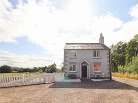 A house with a fence and pathway at Burgedin Locks Cottage Arddleen near Llandrinio