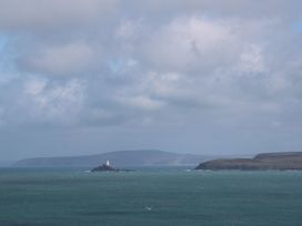 A view of a lighthouse on an island near the coast at Azure in Carbis Bay