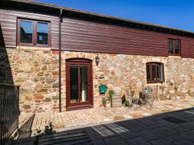 An outdoor area with stone wall and seating at 3 Town Farm Court Newton Abbot