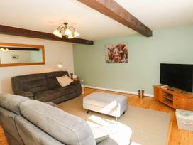 A living room with a sofa and TV at 3 Town Farm Court, Newton Abbot