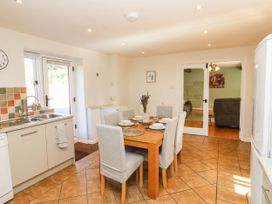 A kitchen with a dining table and chairs at 3 Town Farm Court in Newton Abbot