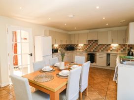 A kitchen with a dining table and chairs at 3 Town Farm Court in Newton Abbot