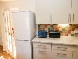 A kitchen with a refrigerator and a toaster at 3 Town Farm Court Newton Abbot