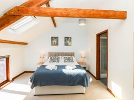 A bedroom with a bed and bedside table at 3 Town Farm Court Newton Abbot
