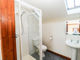 A bathroom with a shower, toilet, and sink at 3 Town Farm Court, Newton Abbot