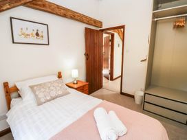 A bedroom with a bed and wardrobe at 3 Town Farm Court in Newton Abbot