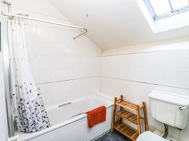 A bathroom with a bathtub and shower at 3 Town Farm Court Newton Abbot