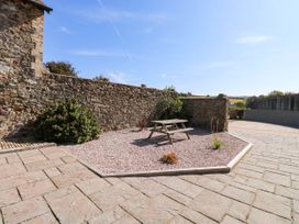 An outdoor space with a picnic table and gravel at 3 Town Farm Court Newton Abbot