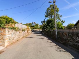 A road with stone wall and trees at 3 Town Farm Court Newton Abbot